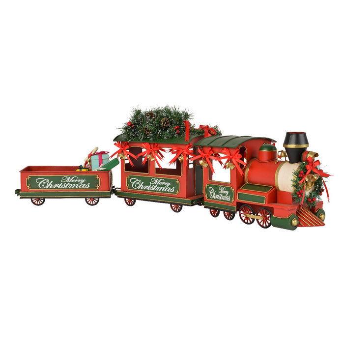 Treno in ferro con regali, bacche e pigne per decorazione natalizia