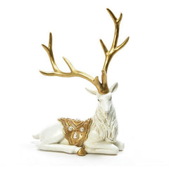 Renna seduta in resina bianco e oro per decorazione natalizia