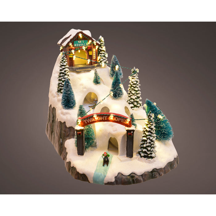 Scena natalizia con pista da sci, movimento e luce a LED