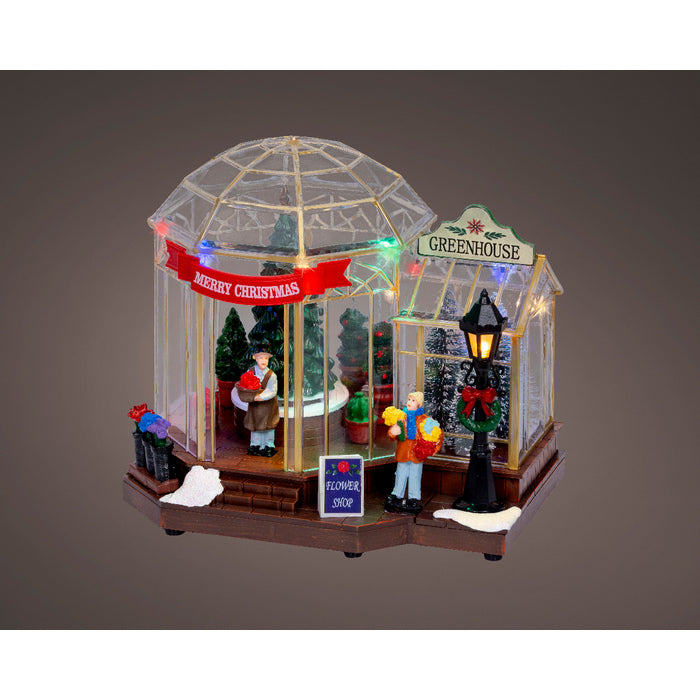 Scena natalizia serra con alberi, movimento, musica e LED