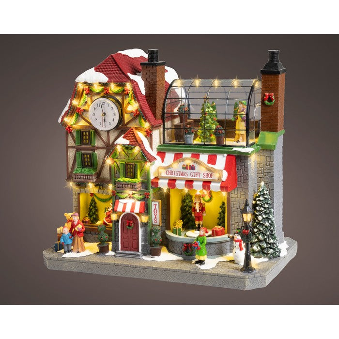 Scenario per villaggio natalizio in poliresina Gift Shop con musica, movimento e LED 44 cm